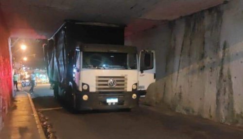 Caminhão baú alto fica enroscado em viaduto em Osvaldo Cruz