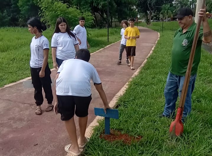 Alunos da EE Helen Keller instalam placas motivacionais nas margens do Córrego Caldeira.